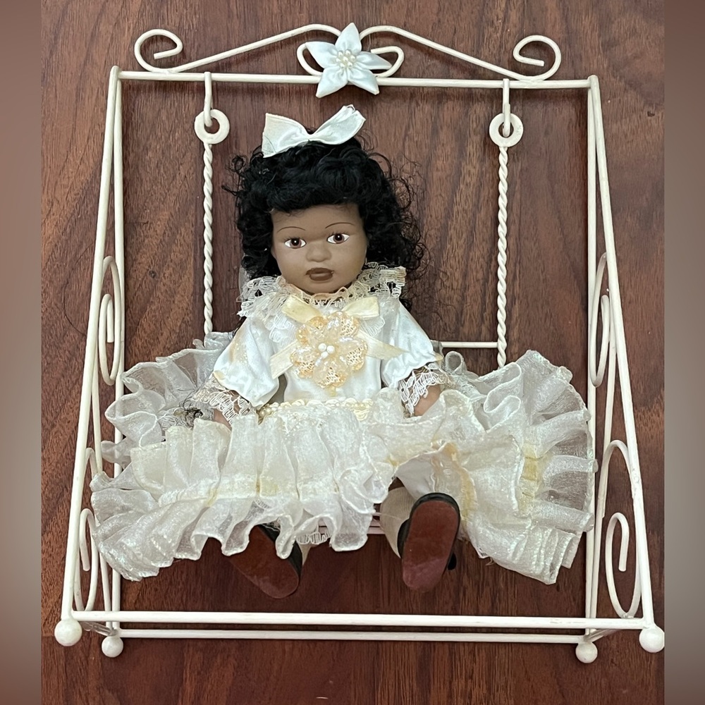 Porcelain Doll with Cream Dress on Swing